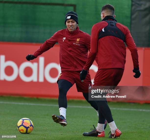 Roberto Firmino and Marko Grujic of Liverpool during a training session at Melwood Training Ground on December 28, 2017 in Liverpool, England.