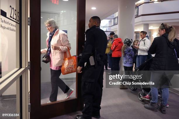 Residents wait in line to pay taxes at the Fairfax County Government Center December 28, 2017 in Fairfax, Virginia. Many people are pre-paying their...