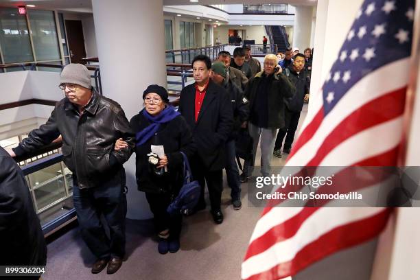 Residents wait in line to pay taxes at the Fairfax County Government Center December 28, 2017 in Fairfax, Virginia. Many people are pre-paying their...