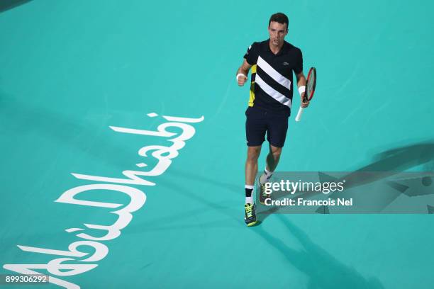 Roberto Bautista Agut of Spain celebrates victory against Andrey Rublev of Russia during his men's singles match on day one of the Mubadala World...