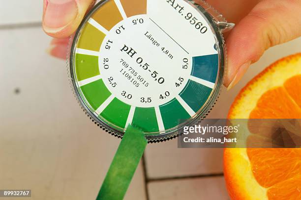 ph value determination orange fruit - ph balance stock pictures, royalty-free photos & images