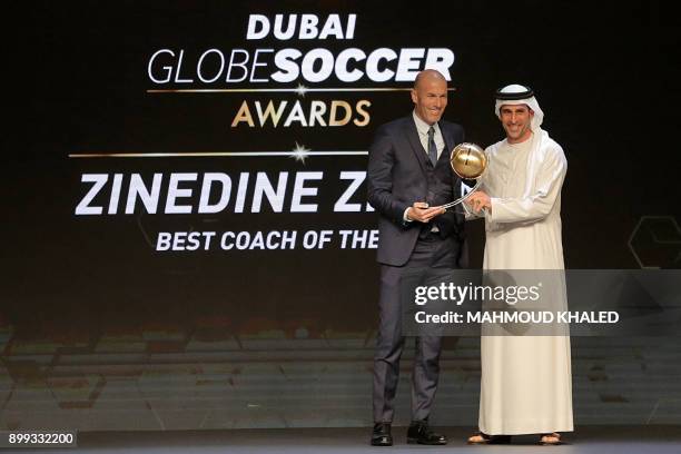 Real Madrid's French coach Zinedine Zidane holds the "Best Coach" award during the Globe Soccer Awards Ceremony at the end of the 12th Edition of the...