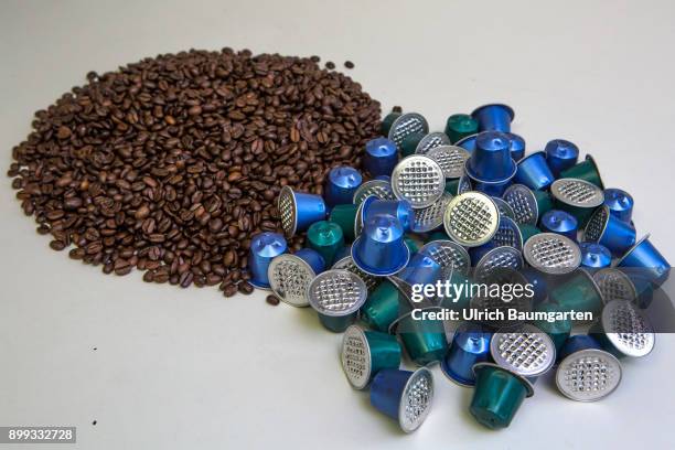 Symbol photo on the topic coffee, enviroment, waste, etc. The picture shows coffee beans and coffee capsules.