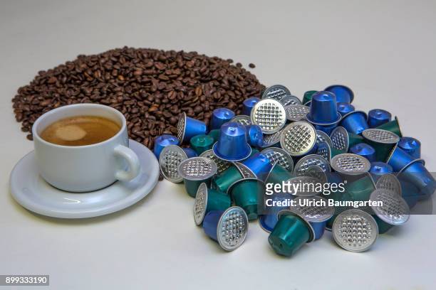 Symbol photo on the topic coffee, enviroment, waste, etc. The picture shows coffee beans, coffee capsules and a cup of coffee.