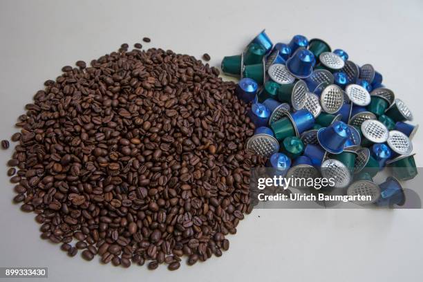 Symbol photo on the topic coffee, enviroment, waste, etc. The picture shows coffee beans and coffee capsules.