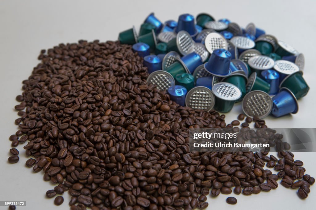Symbol photo on the topic coffee. Coffee beans and coffee capsules.