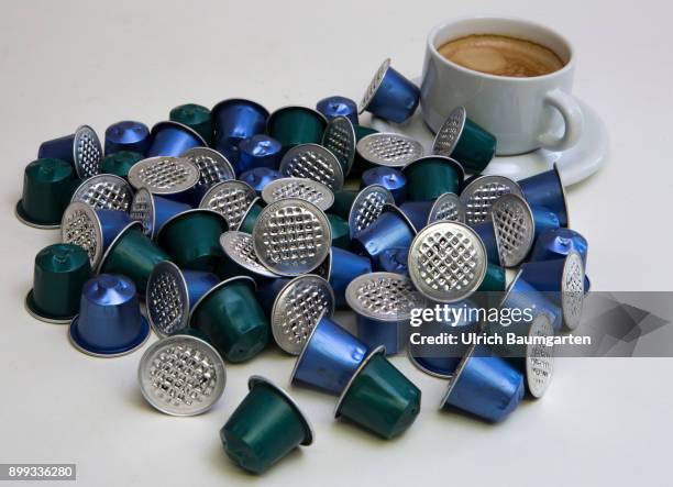 Symbol photo on the topic coffee, enviroment, waste, etc. The picture shows coffee capsules and a cup of coffee.