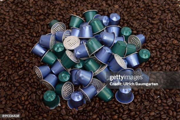 Symbol photo on the topic coffee, enviroment, waste, etc. The picture shows coffee beans and coffee capsules.