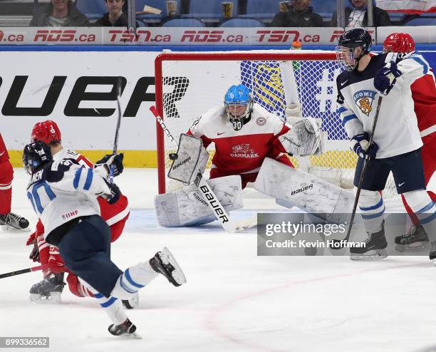 Kasper Krog of Denmark makes the save against Eeli Tolvanen of Finland in the third period during the IIHF World Junior Championship at KeyBank...