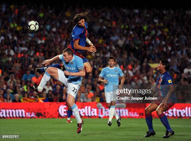 Zlatan Ibrahimovic of Barcelona duels in the air with Richard Dunne of Manchester City during the Joan Gamper Trophy match between Barcelona and...