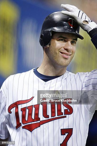 Joe Mauer of the Minnesota Twins smiles as he prepares to bat against the Kansas City Royals on August 13, 2009 at the Metrodome in Minneapolis,...