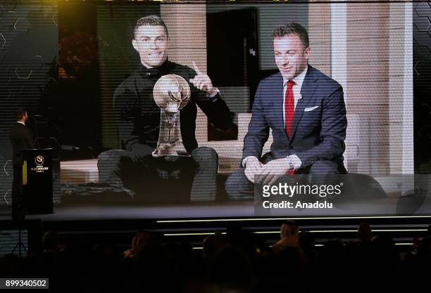 Football player of Real Madrid Cristiano Ronaldo delivers a speech via teleconference as he sits beside Italian former football player Alessandro Del...