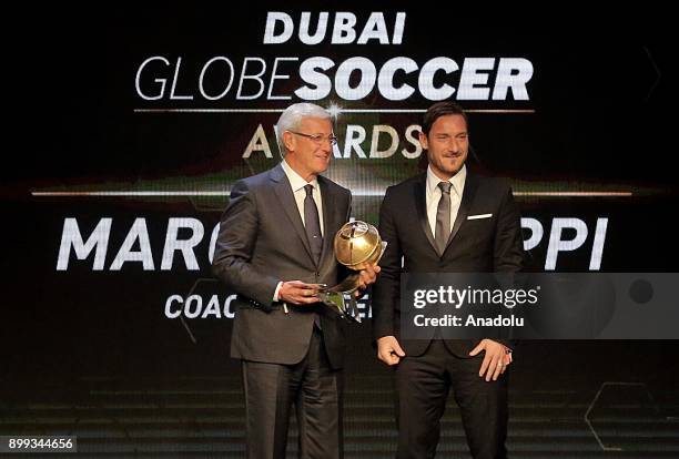 Head coach of China Marcello Lippi receives 'Coach Career' award from former football player Francesco Totti during the Globe Soccer Awards Ceremony...