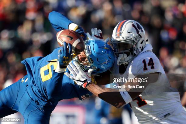 Safety Sean Williams of the Navy Midshipmen intercepts a pass intended for wide receiver Andre Levrone of the Virginia Cavaliers in the first half of...