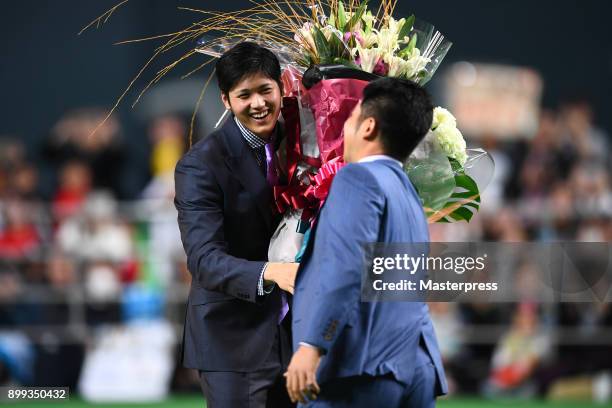 Shohei Ohtani of the Los Angeles Angels receives a flower bunch during his farewell event at Sapporo Dome on December 25, 2017 in Sapporo, Hokkaido,...