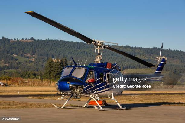 Bell UH-1 helicopter is parked on the tarmac at the Chehalem Airpark on September 29 in Newberg, Oregon. Dundee, Carlton, McMinnville, and Newburg,...