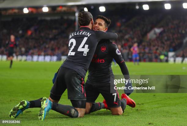 Alexis Sanchez of Arsenal celebrates as he scores their third goal with Hector Bellerin during the Premier League match between Crystal Palace and...