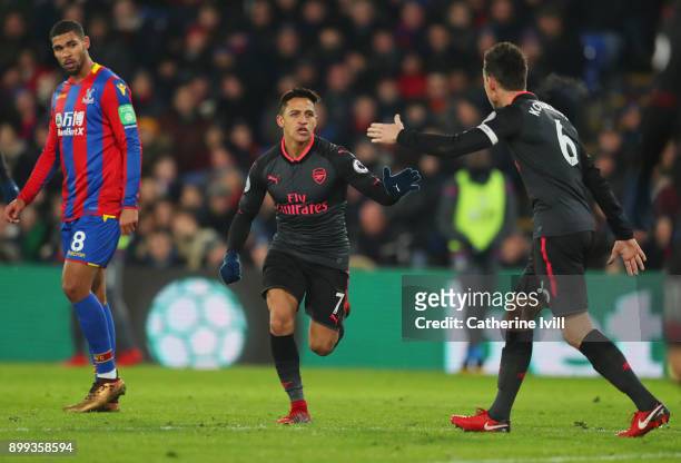 Alexis Sanchez of Arsenal celebrates as he scores their second goal with Laurent Koscielny during the Premier League match between Crystal Palace and...