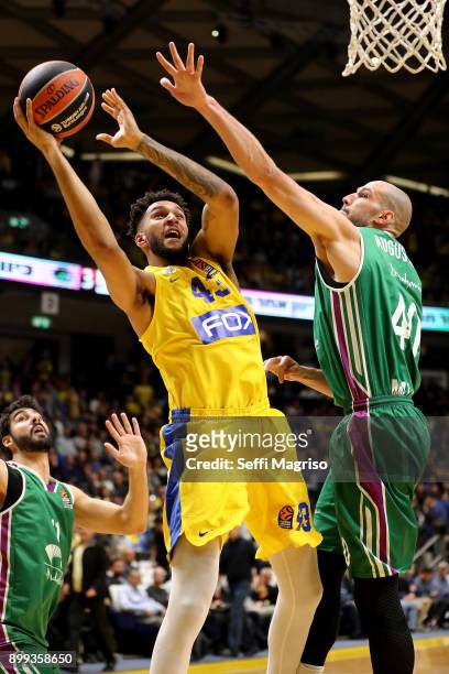 Jonah Bolden, #43 of Maccabi Fox Tel Aviv competes with James Augustine, #40 of Unicaja Malaga during the 2017/2018 Turkish Airlines EuroLeague...