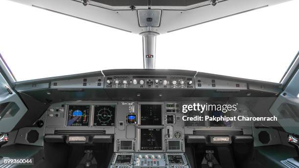 a view of the cockpit of a large commercial airplane a cockpit trainer. cockpit view of a commercial aircraft cruising control panel in a plane cockpit. - airplane cockpit stock pictures, royalty-free photos & images