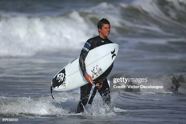 Raia walks up the beach after Heat 3 of the Round of 64 of the Nike 6.0 Pro Junior Men's Grade 2 event as part of the 2009 Hurley U.S. Open of...