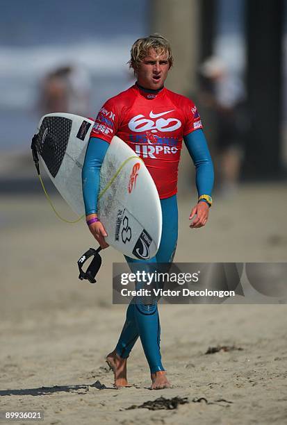 Charles Martin walks up the beach after Heat 5 of the Round of 64 of the Nike 6.0 Pro Junior Men's Grade 2 event as part of the 2009 Hurley U.S. Open...