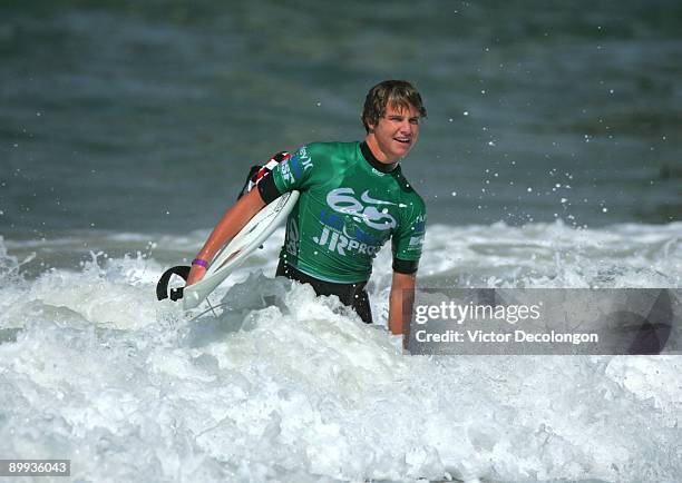 Keto Burns walks through the whitewater after Heat 6 of the Round of 64 of the Nike 6.0 Pro Junior Men's Grade 2 event as part of the 2009 Hurley...