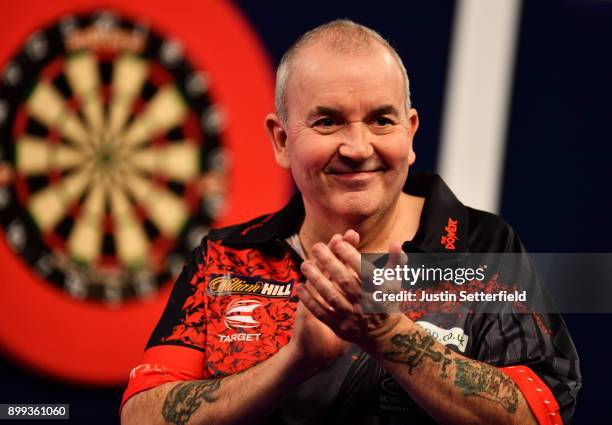 Phil Taylor celebrates after winning his Third Round Match against Keegan Brownduring the 2018 William Hill PDC World Darts Championships on Day...