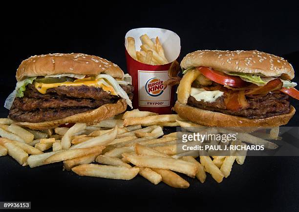 Burger King's two big boy burgers, the "BK Quad Stacker" with four beef patties, topped with bacon, cheese, sauce, lettuce, pickles, onions seen...