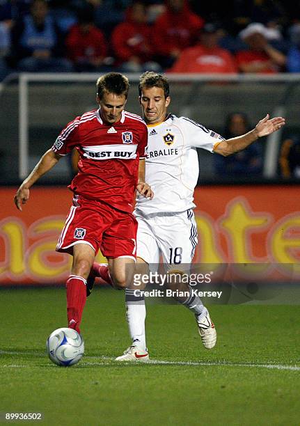 Chris Rolfe of the Chicago Fire moves the ball as Mike Magee of the Los Angeles Galaxy defends during the second half at Toyota Park August 19, 2009...