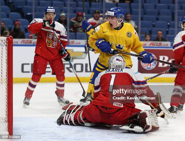 Glenn Gustafsson of Sweden celebrates a goal against Jakub Skarek of Czech Republic in the first period during the IIHF World Junior Championship at...