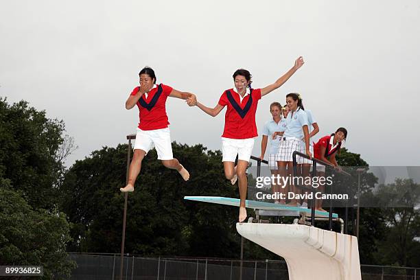 Team members leap into the pool after play had finished during the final day of the 2009 Junior Solheim Cup Matches, at the Aurora Country Club on...