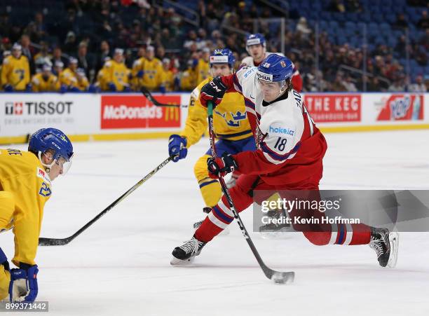 Filip Zadina of Czech Republic takes a shot as Jacob Moverare of Sweden defends in the second period during the IIHF World Junior Championship at...