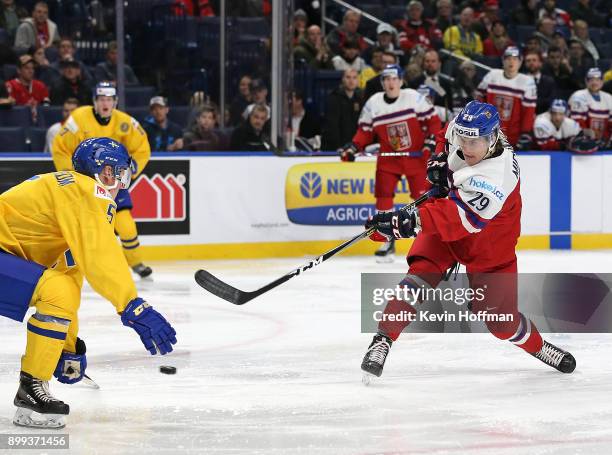 Albert Michnac or Czech Republic takes a shot as Gustav Lindstrom of Sweden defends in the second period during the IIHF World Junior Championship at...