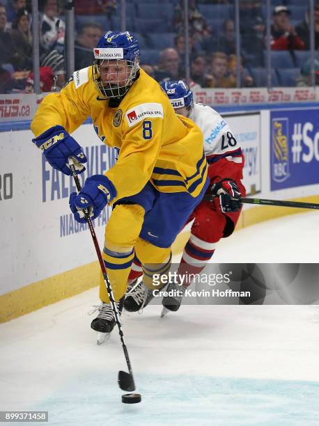 Rasmus Dahlin of Sweden with the puck as Petr Kodytek of Czech Republic pursues in the second period during the IIHF World Junior Championship at...