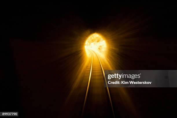 rail tunnel towards golden light, blurred motion   - westerskov stock pictures, royalty-free photos & images