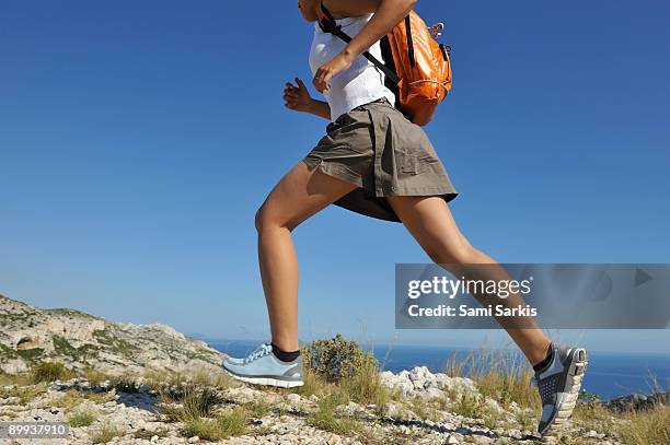 woman running on a hike in the calanques - cassis stock-fotos und bilder