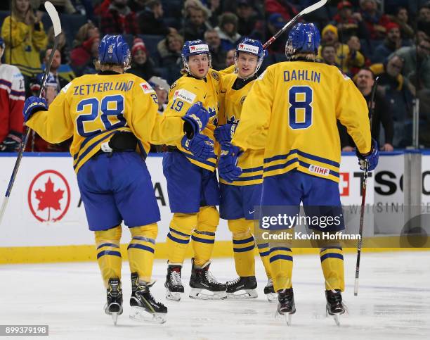 Alexander Nylander of Sweden celebrates with teammates after scoring a goal in the third period against Czech Republic during the IIHF World Junior...