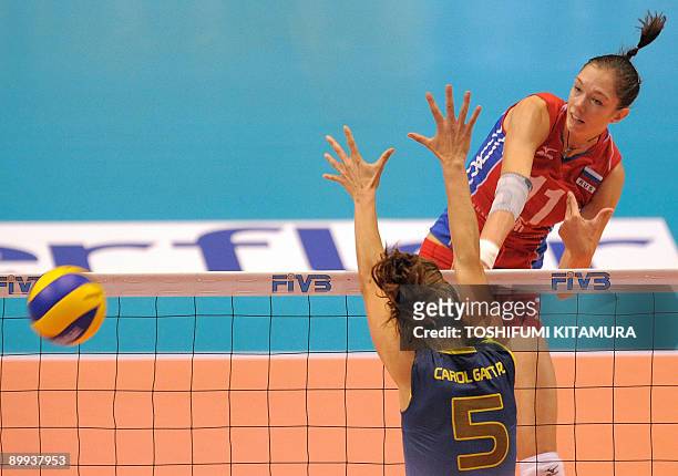 Russia's Ekaterina Gamova spikes the ball past Brazilian Caroline Gattaz during their 2009 FIVB World Grand Prix women's volleyball final round match...
