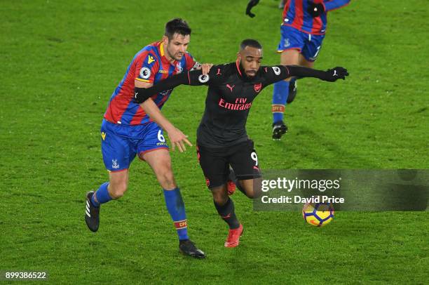 Alexandre Lacazette of Arsenal is challenged by Scott Dann of Palace during the Premier League match between Crystal Palace and Arsenal at Selhurst...