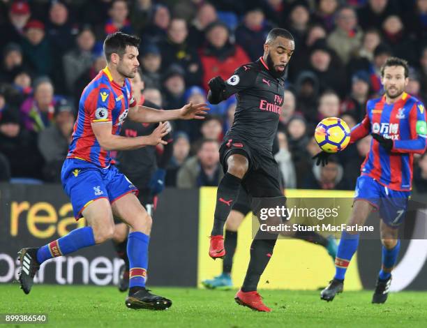 Alex Lacazette of Arsenal holds off Scott Dann of Palace during the Premier League match between Crystal Palace and Arsenal at Selhurst Park on...