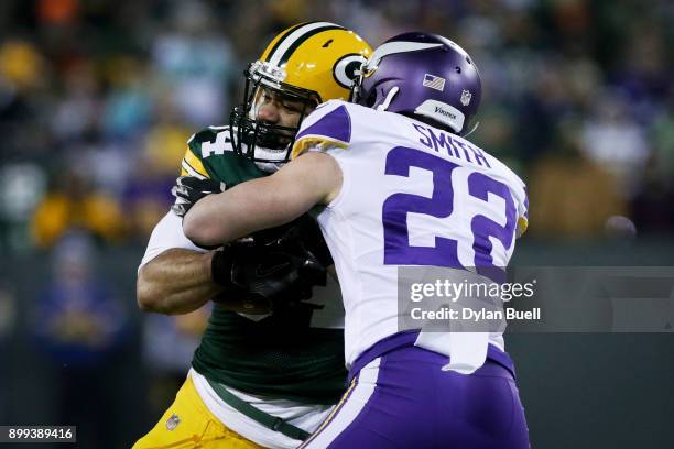 Harrison Smith of the Minnesota Vikings tackles Lance Kendricks of the Green Bay Packers in the second quarter at Lambeau Field on December 23, 2017...