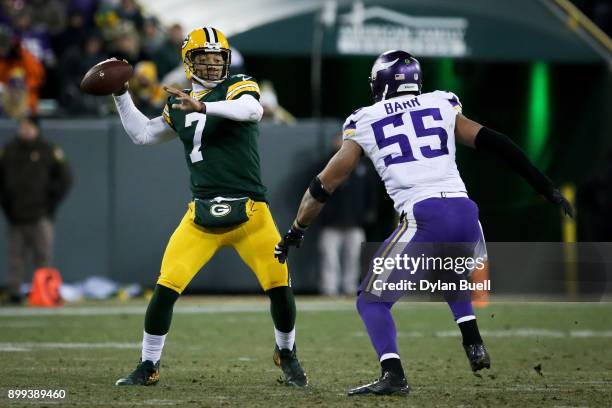 Brett Hundley of the Green Bay Packers throws a pass while being pressured by Anthony Barr of the Minnesota Vikings in the third quarter at Lambeau...