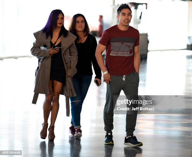 Cynthia Calvillo arrives with coach Justin Buchholz during the UFC 219 Ultimate Media Day inside T-Mobile Arena on December 28, 2017 in Las Vegas,...