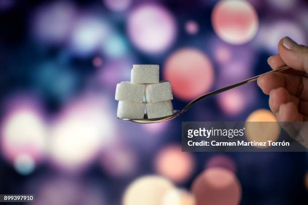 sugar cubes on teaspoon. - diabetes and nobody stock pictures, royalty-free photos & images