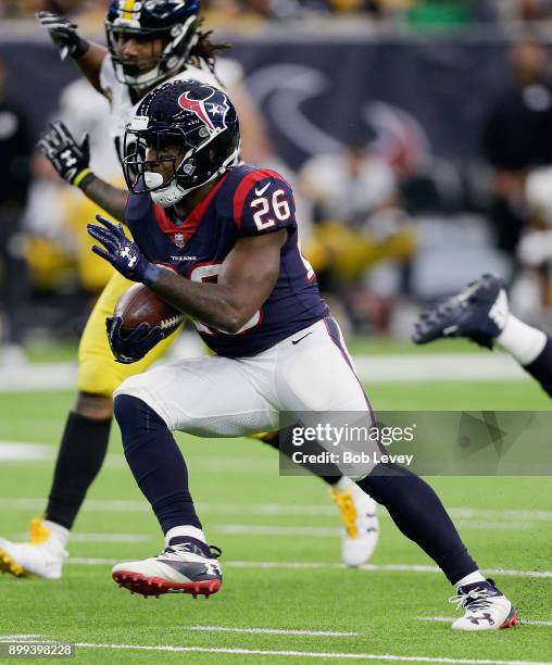 Lamar Miller of the Houston Texans runs with the ball against the Pittsburgh Steelers during game action at NRG Stadium on December 25, 2017 in...