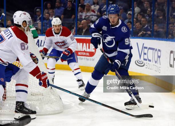 Mikhail Sergachev of the Tampa Bay Lightning looks to pass against the forecheck of Max Pacioretty of the Montreal Canadiens during the first period...