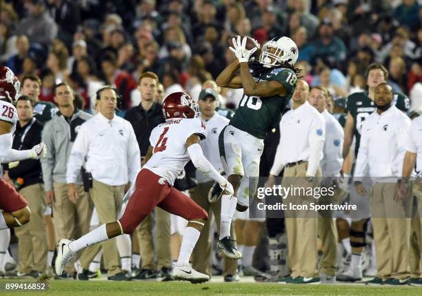 Michigan State Felton Davis III catches a pass against Washington State Marcus Strong during the Holiday Bowl game between the Washington State...