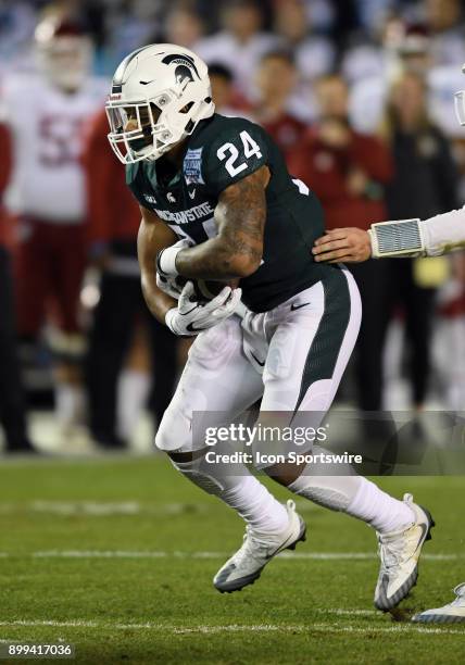 Michigan State Spartans running back Gerald Holmes takes a handoff from quarterback Brian Lewerke in the first half of the Holiday Bowl played...