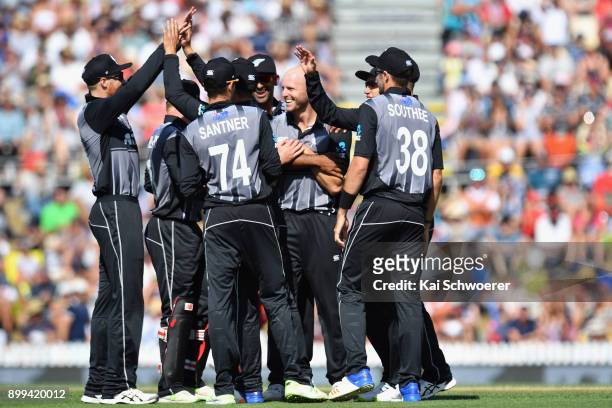 Seth Rance of New Zealand is congratulated by team mates after dismissing Chadwick Walton of the West Indies during game one of the Twenty20 series...